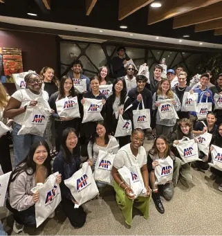 AIP interns with AIP tote bags