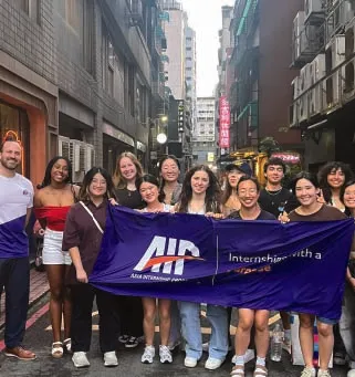 Interns with an AIP banner