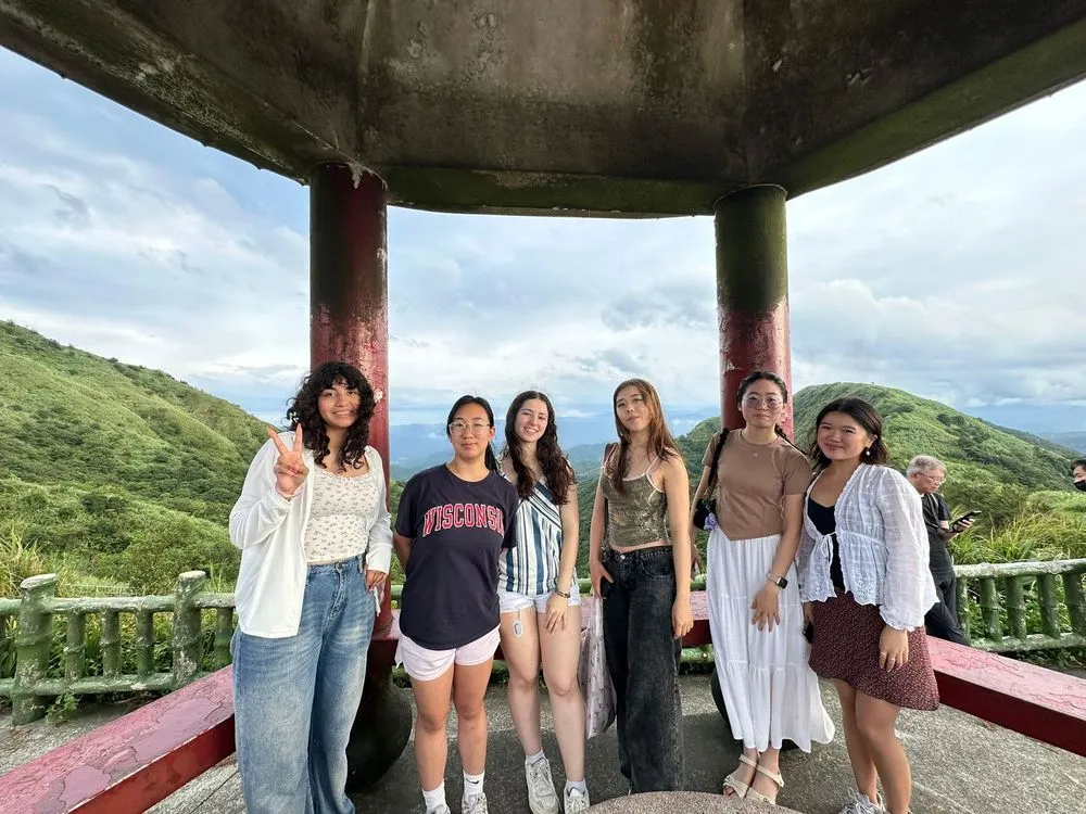 University students on a tea tour with AIP, looking out over green hills