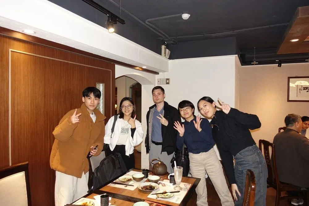 AIP interns at a lookout with Taipei 101 lit up at night