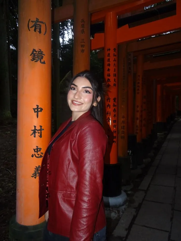 An AIP intern among the red torii gates of Fushimi Inari in Kyoto