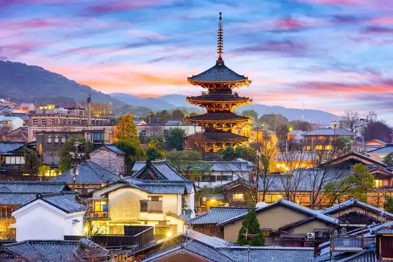 Traditional houses and a pagoda in Kyoto at dusk