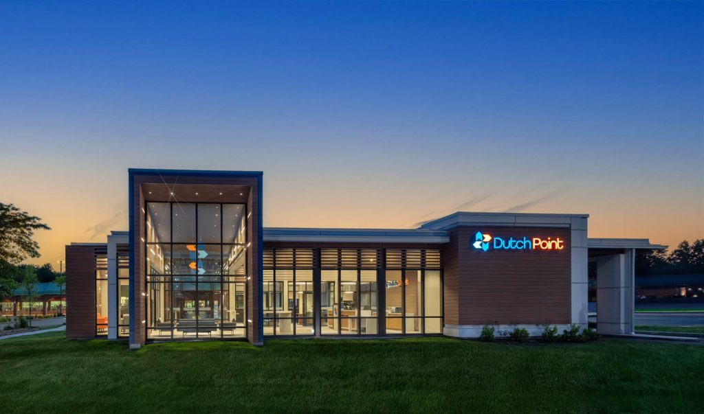 Dutch Point branch exterior at dusk with lit channel letter sign