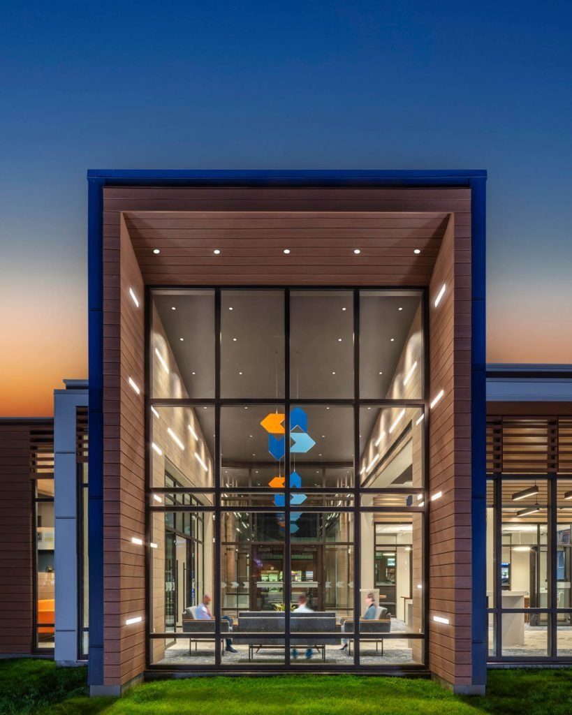 Dutch Point glass entrance with suspended logomark sculptures