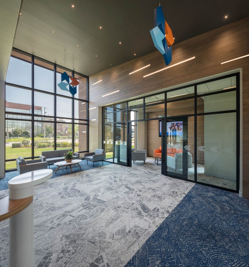 Dutch Point lounge with logomark sculptures and branded glass film
