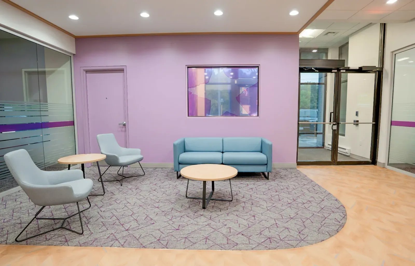 UMassFive lounge with star vinyl window and lavender feature wall