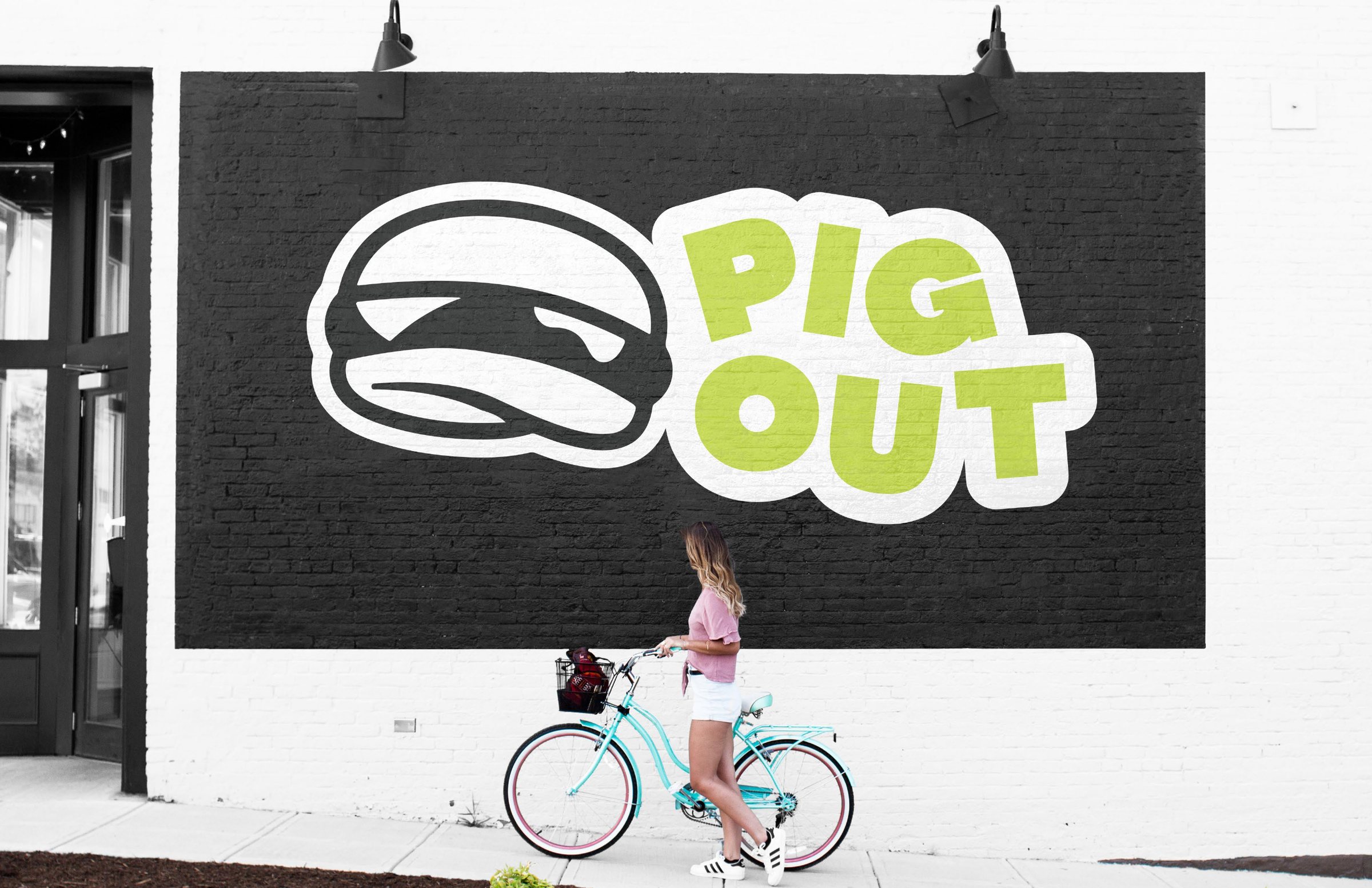 Pig Out logo painted as a large black and green wall mural