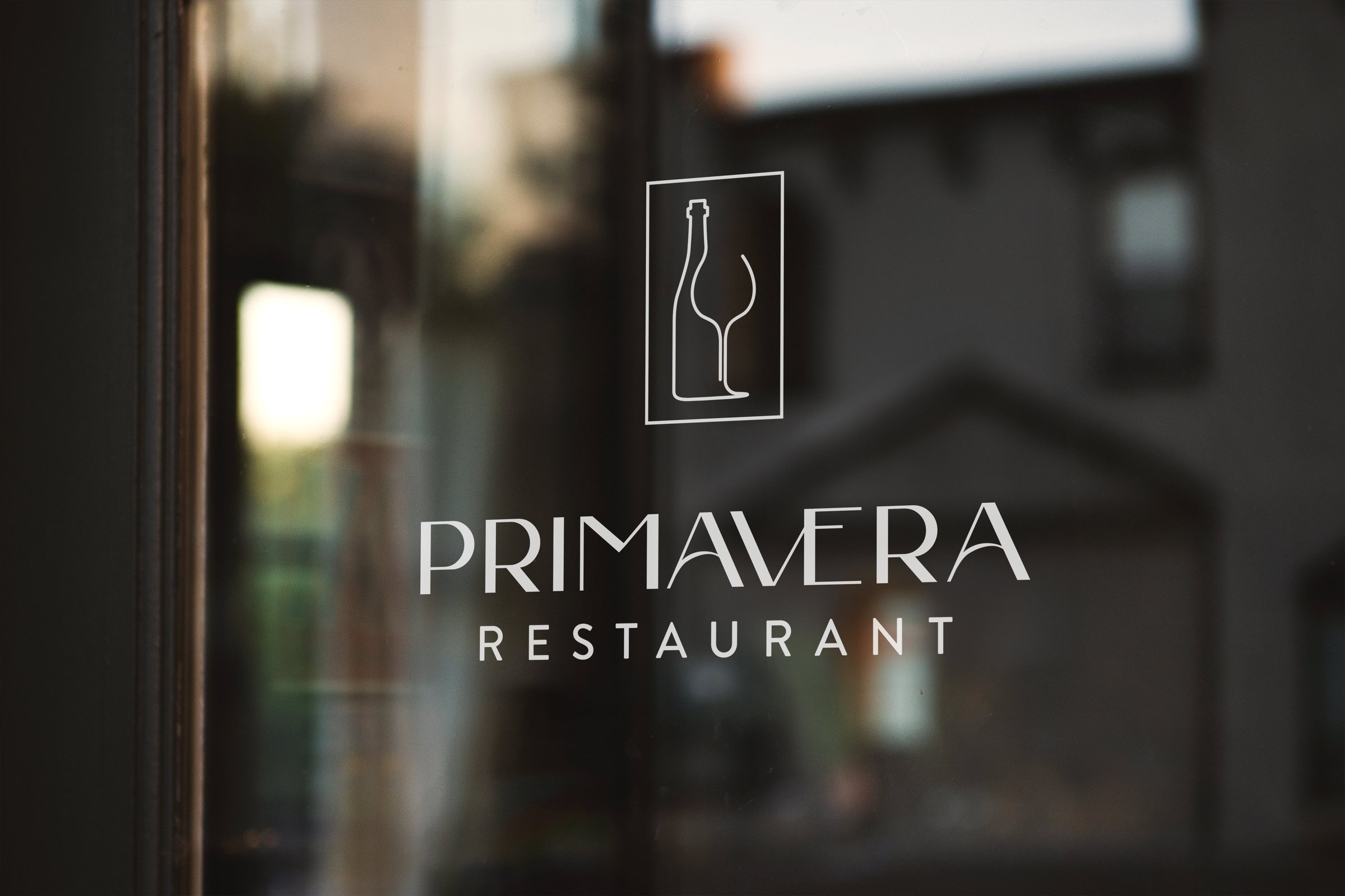 Primavera Restaurant logo as a white window decal on the storefront glass