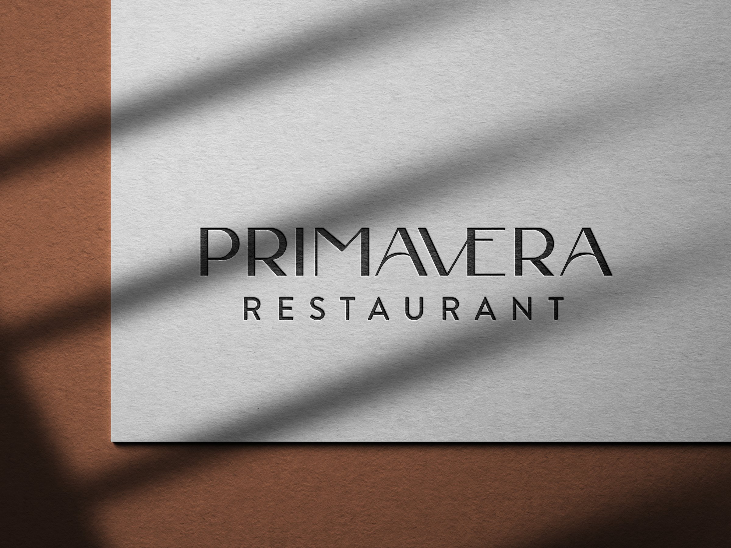 Primavera Restaurant wordmark debossed on textured paper
