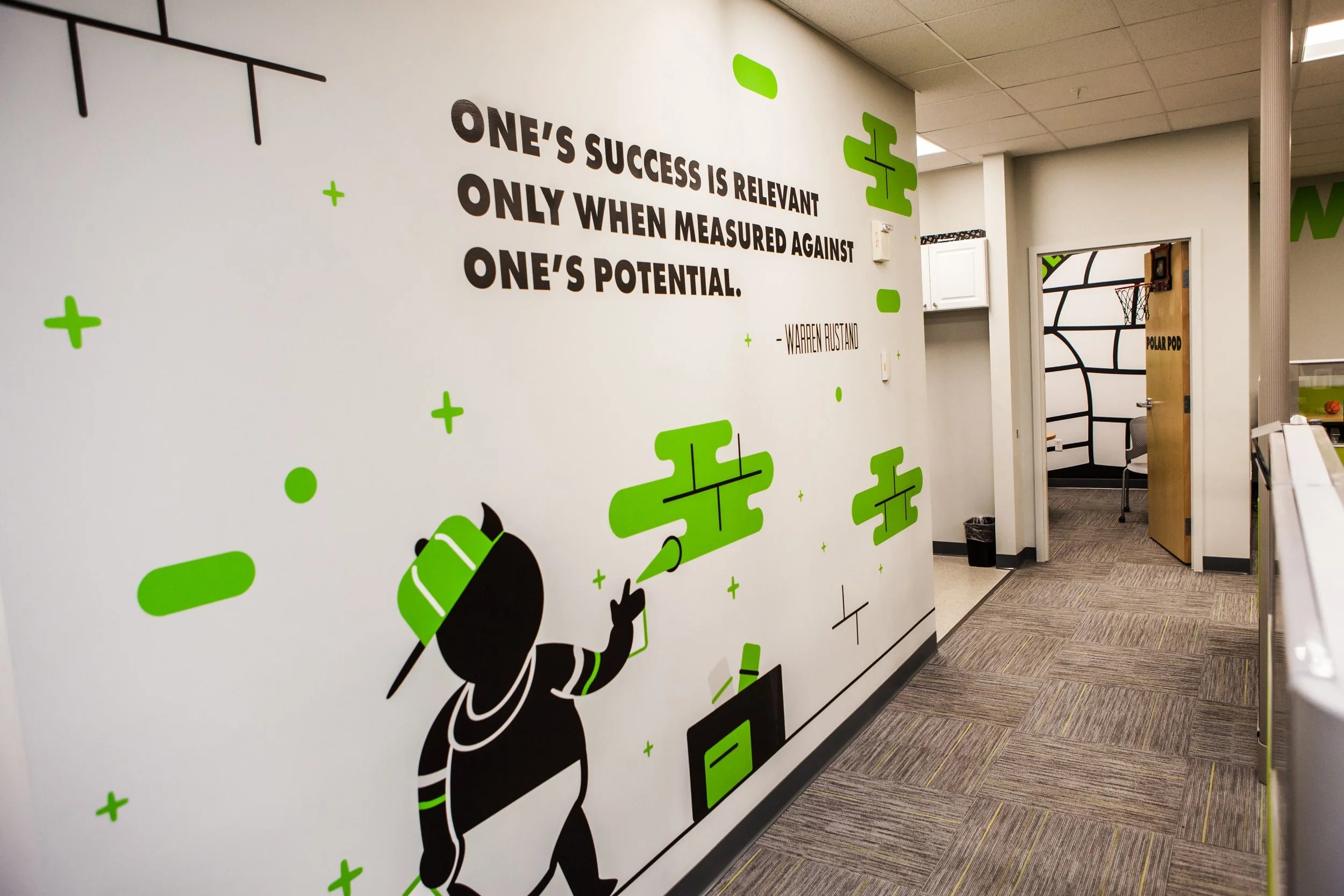 Paragus hallway mural with a Warren Rustand quote and illustrated mascot