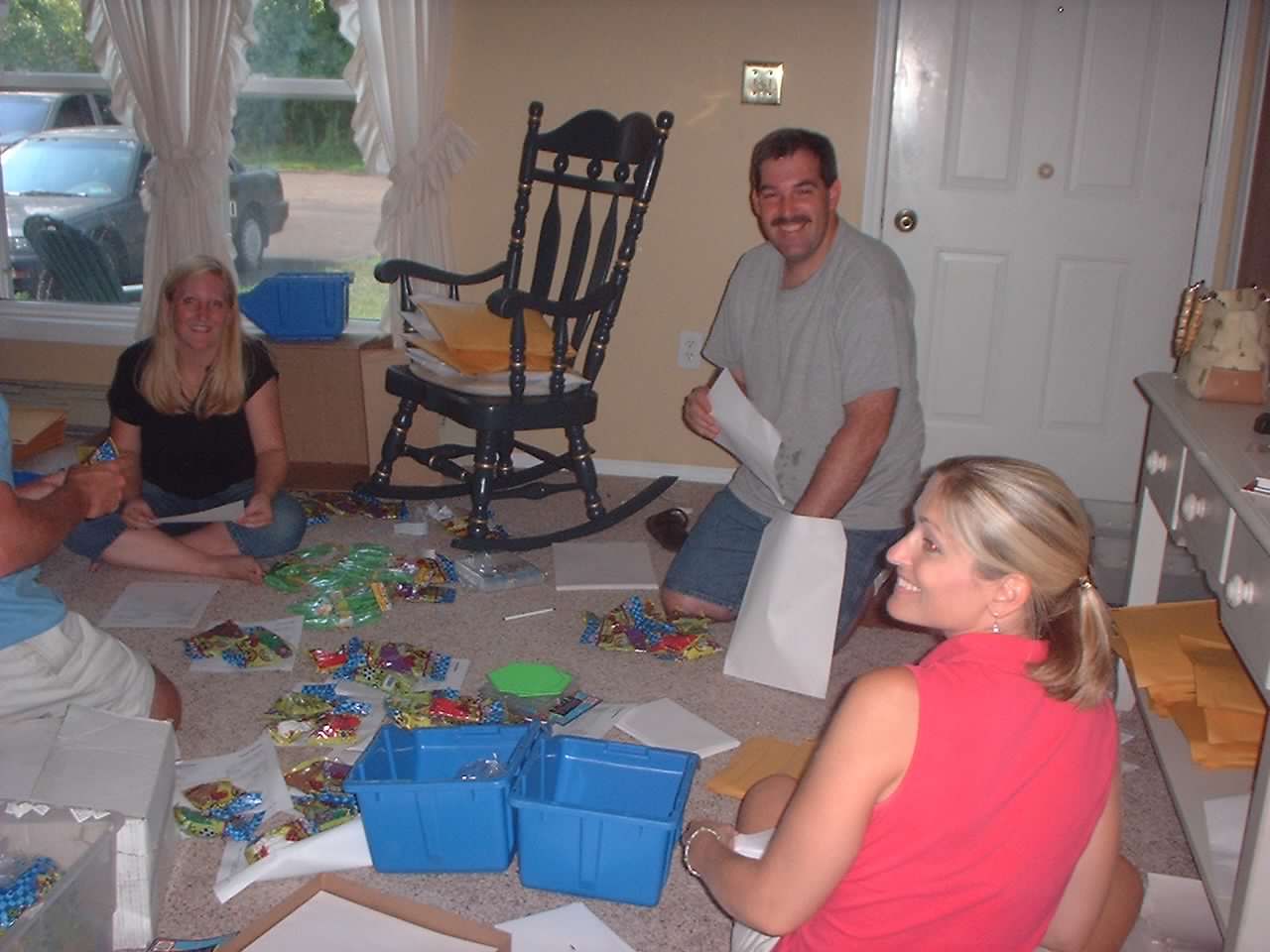Our family packing orders on the living room floor