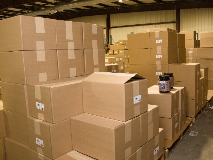 Cases with lot and expiry labels staged on pallets