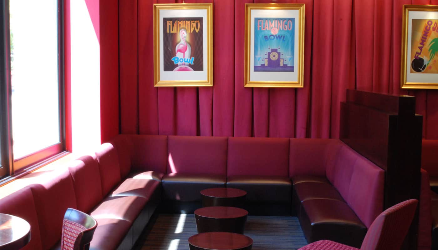 Banquette seating in the Palm Room next to its four lanes