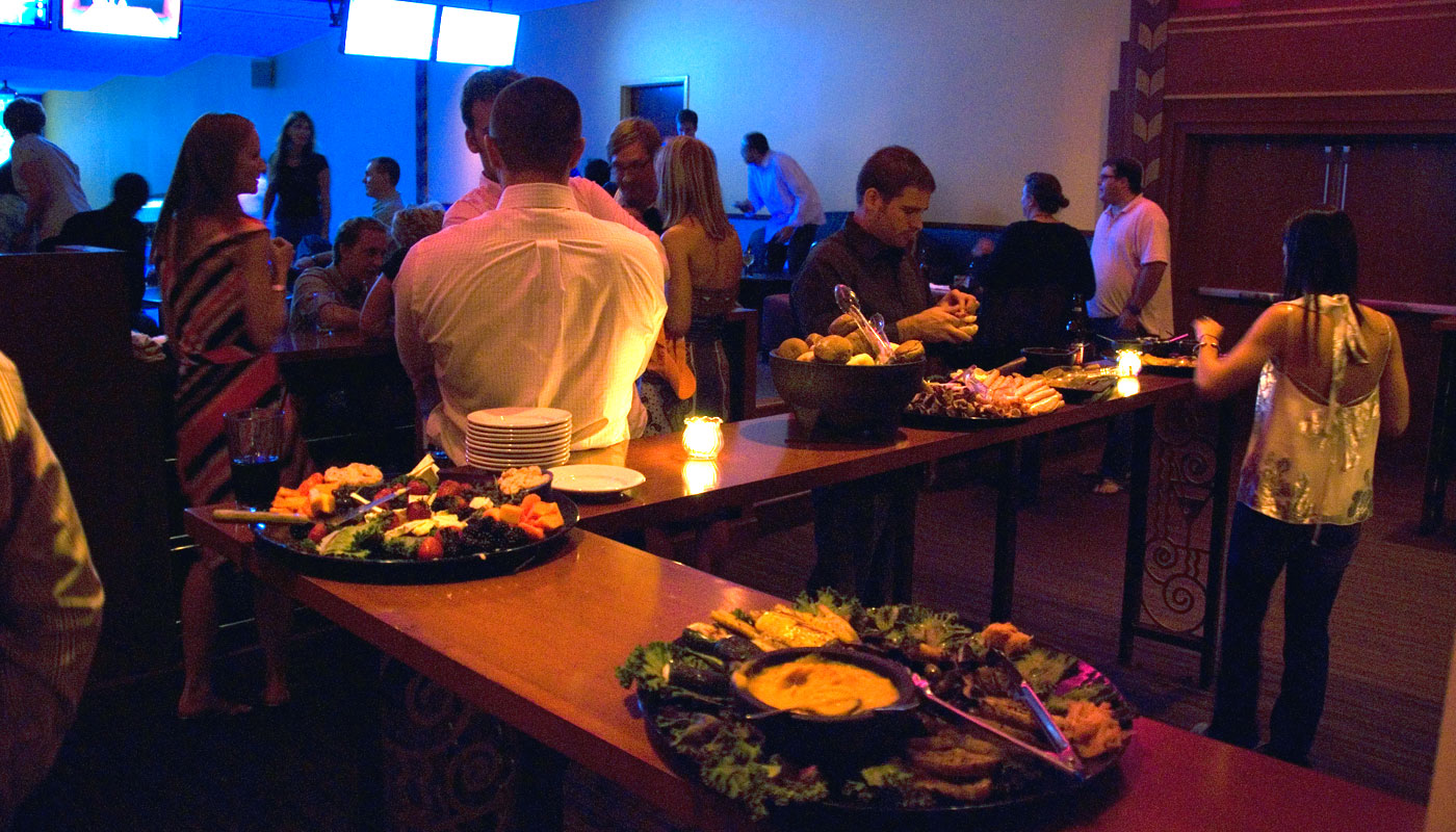 Guests gathered around a catered buffet during a private party