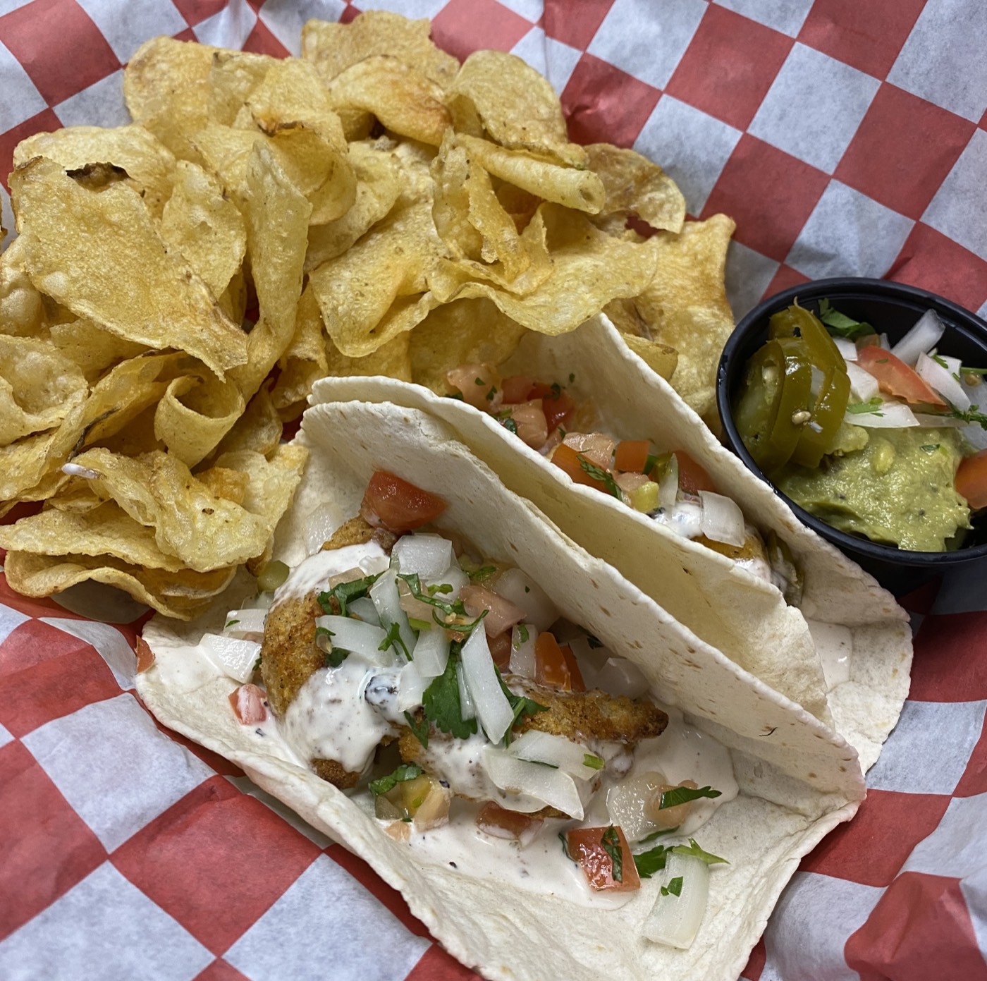Soft tacos topped with pico de gallo, served with chips and guacamole