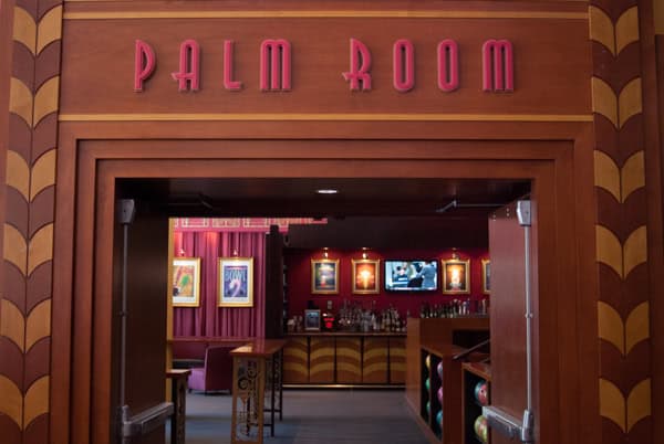 Art-deco entrance to the Palm Room with its name lettered in gold above the doorway