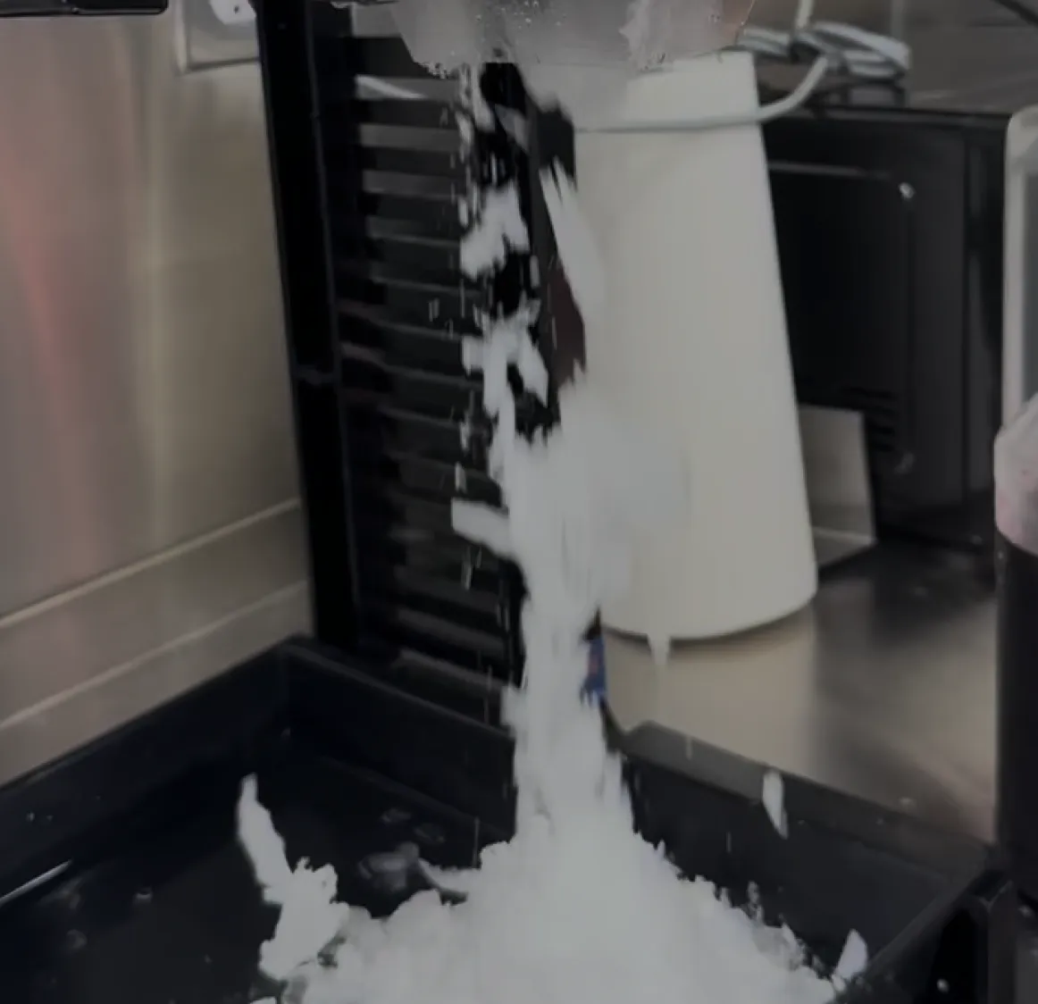 Fresh shaved ice pouring from the machine