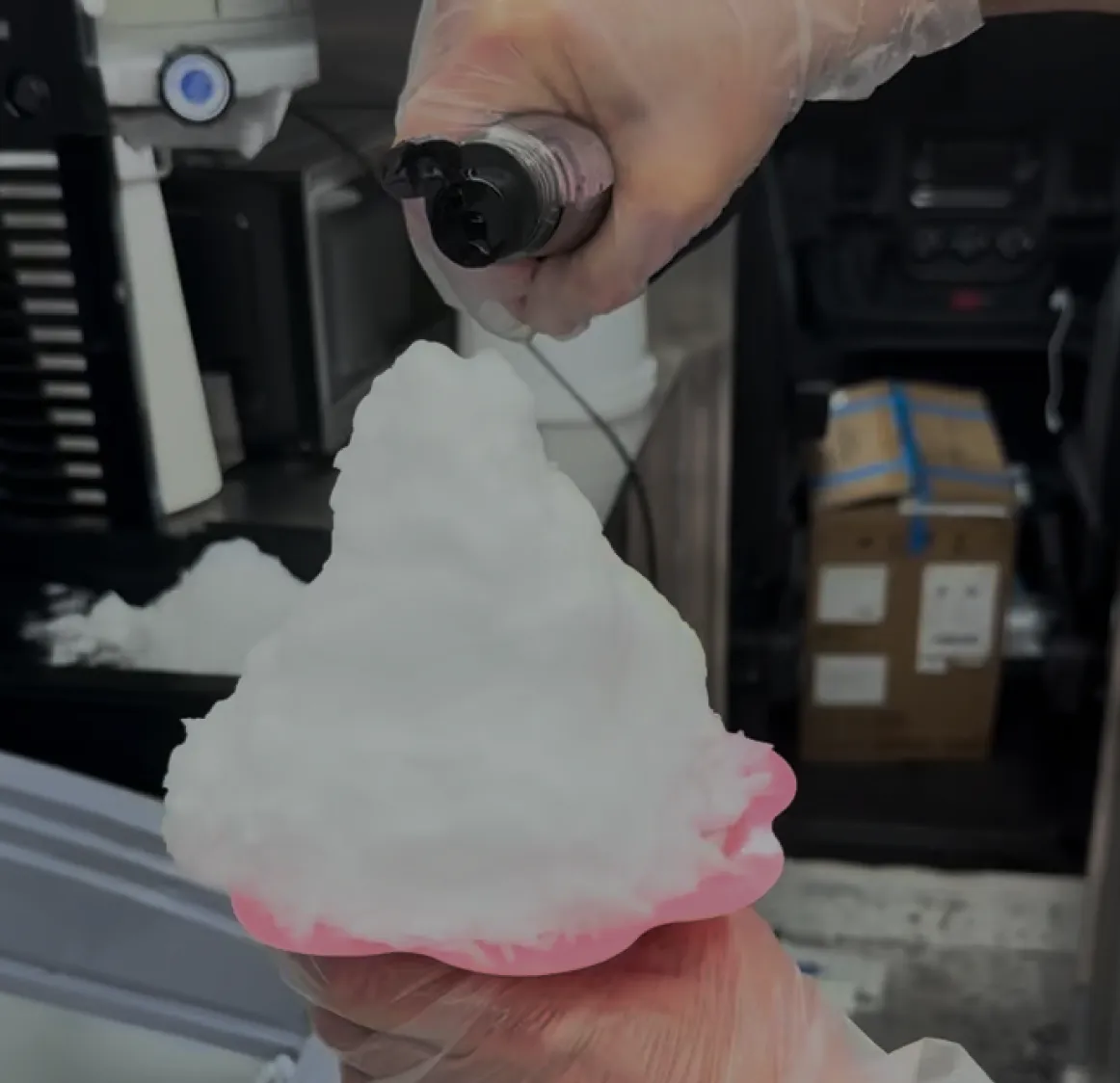 Syrup being poured over a fresh shaved ice