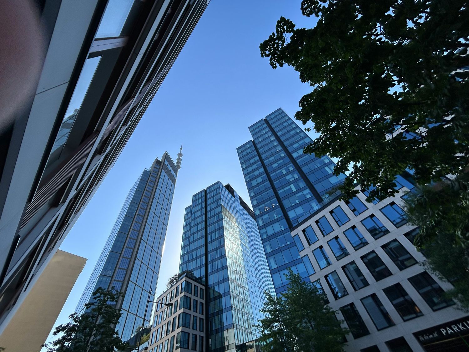 Glass office towers rising against a clear blue sky