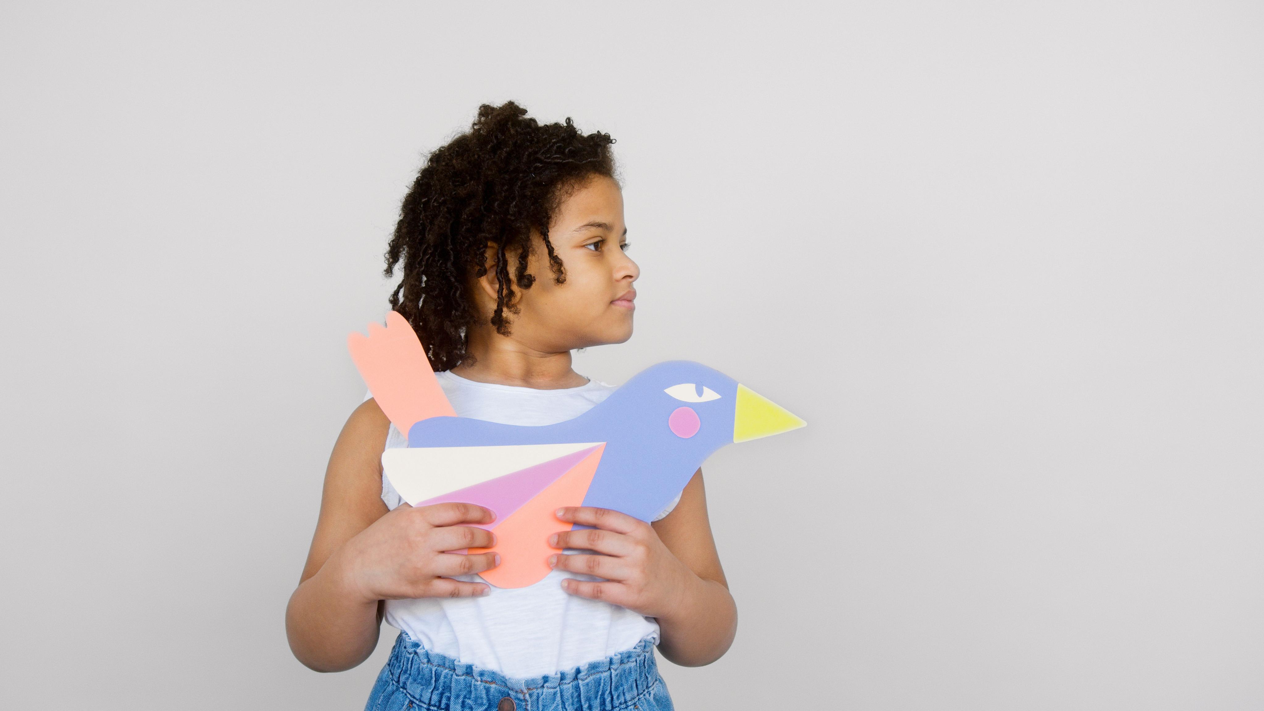 Child holding a paper pigeon