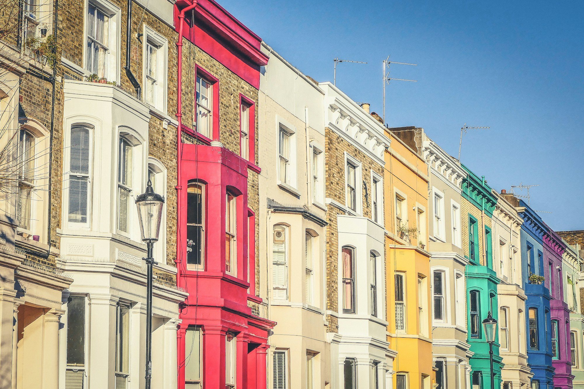Pastel-painted terraced houses on a Notting Hill street
