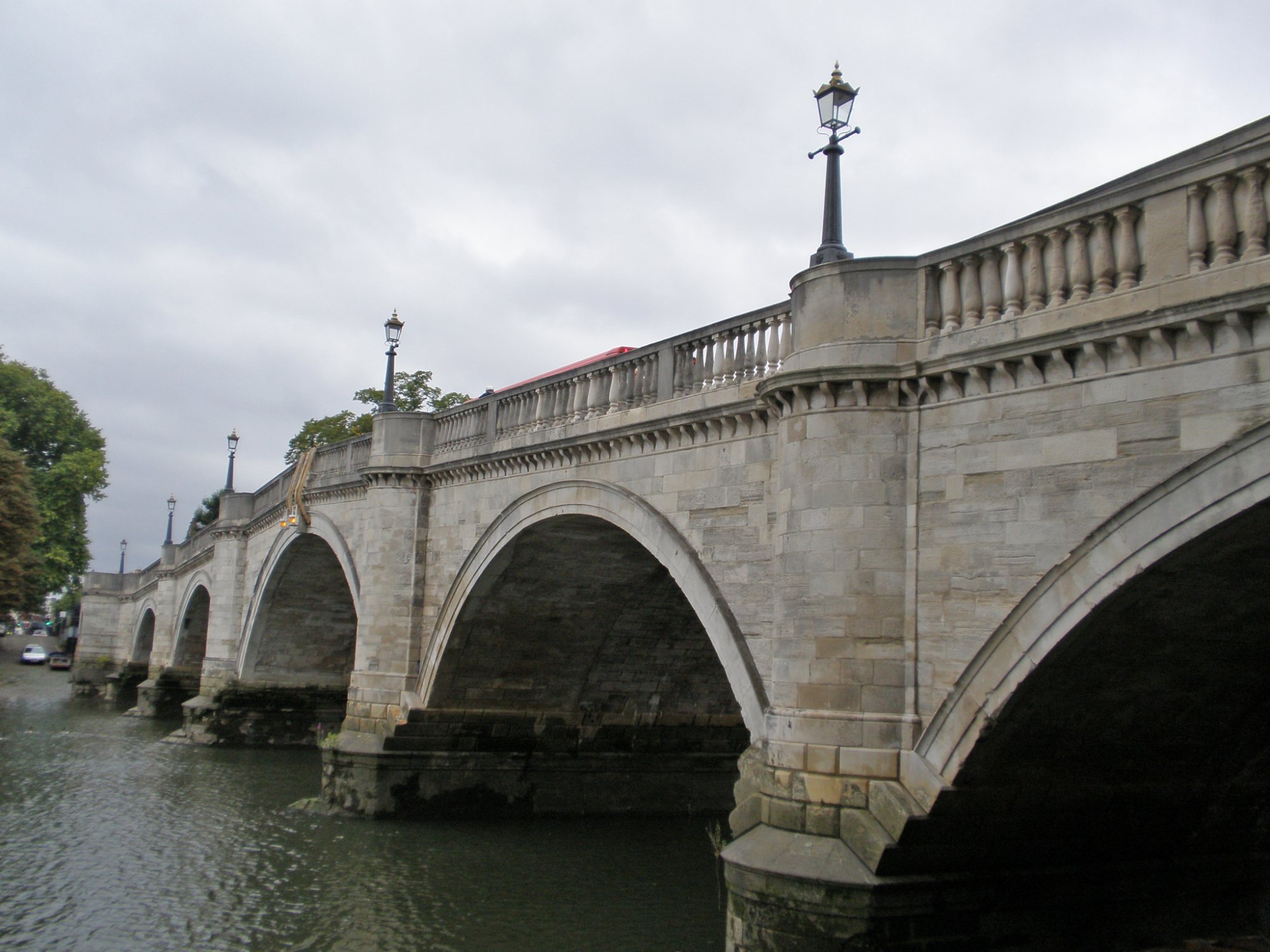 Stone arches of Richmond Bridge over the Thames
