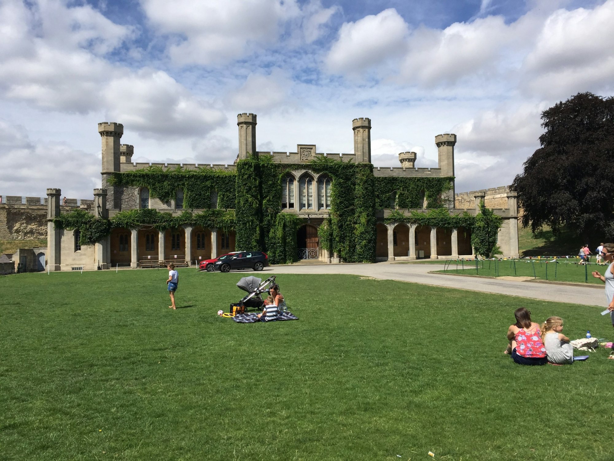 Historic house and lawns with people relaxing