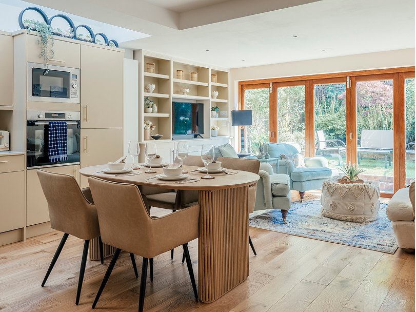 Open-plan kitchen and dining room with garden doors at Gayville Road, Battersea