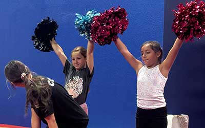 Young girl celebrating at cheer class
