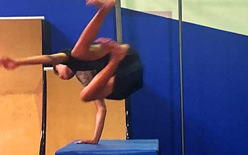 tumbling class positively supporting student doing a back handspring