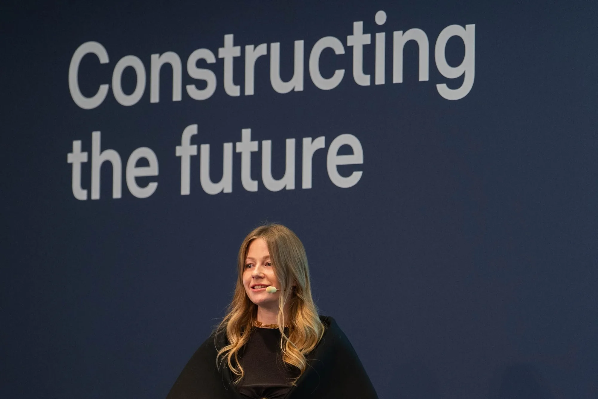 Marie Lepske on stage in front of the slide “Constructing the future” at Constructor Start Demo Day 2026