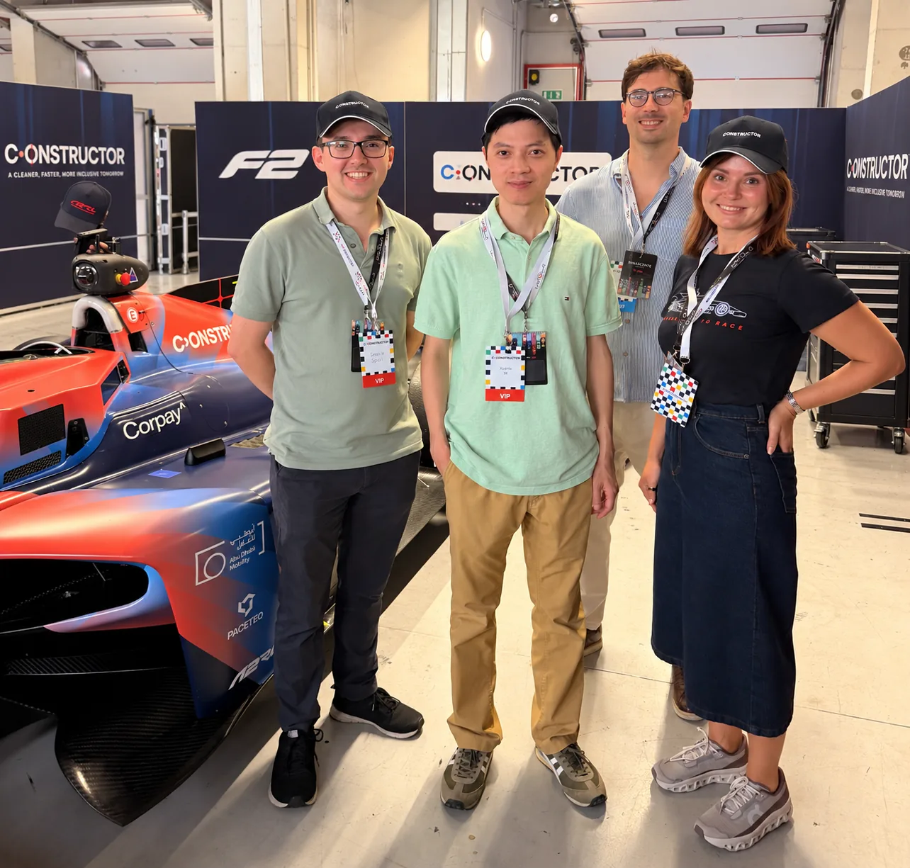 Dr. James Spall, Dr. Xianxin Guo, Dr. Valentino Jadriško and Ana Verkhoff next to the Constructor race car in the pit garage at Imola