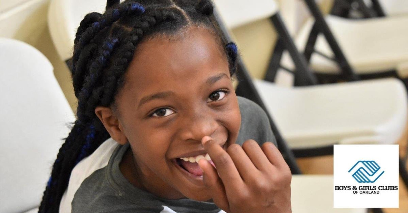 Smiling girl with braided hair at a Boys & Girls Clubs of Oakland club