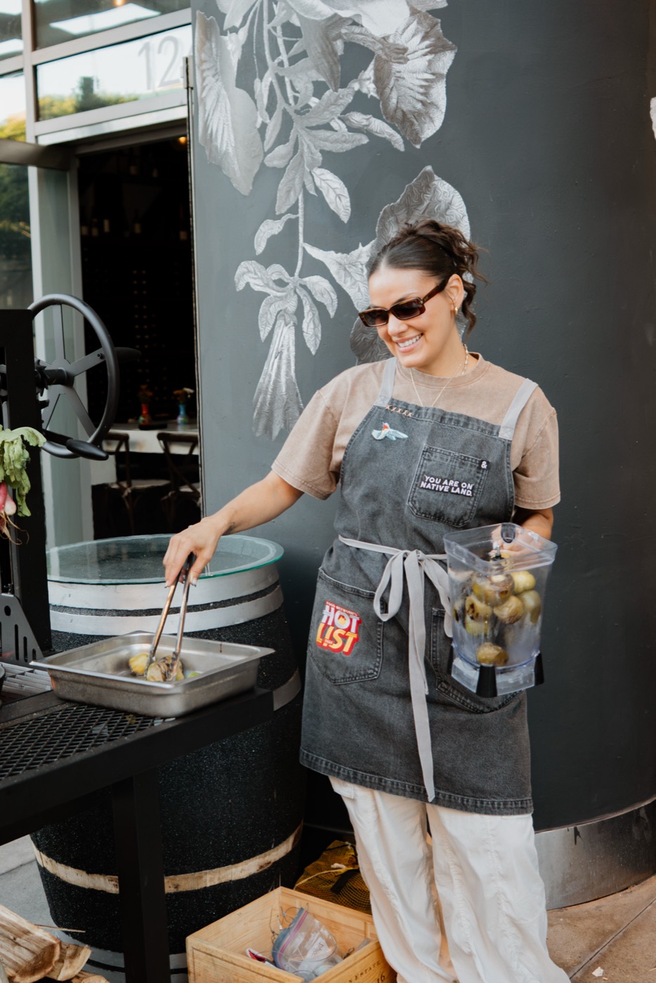 A chef laughing at the grill station