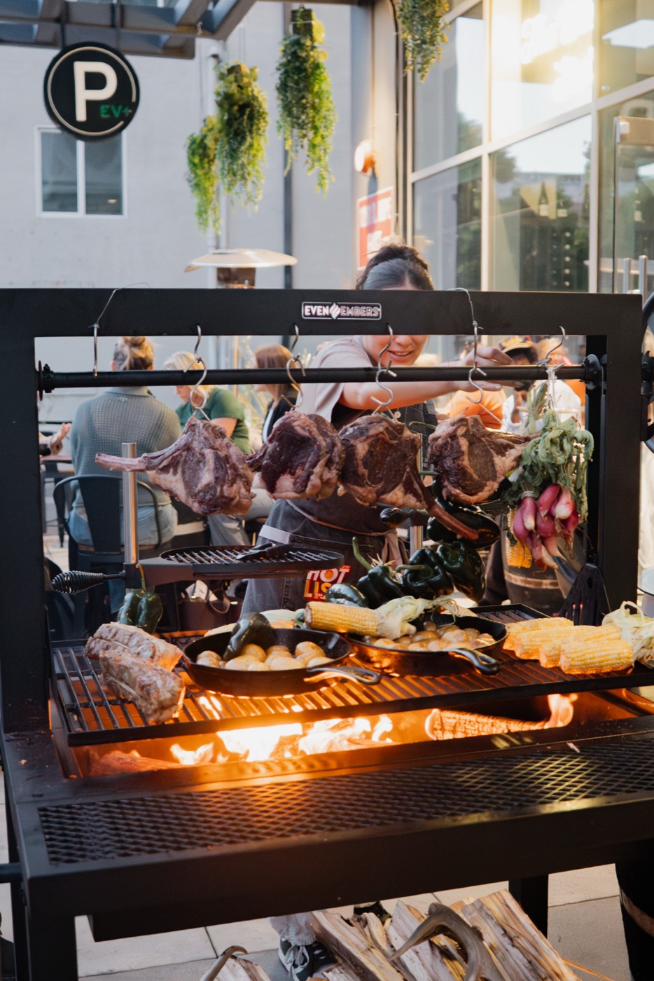 Live-fire grill loaded with meats and vegetables