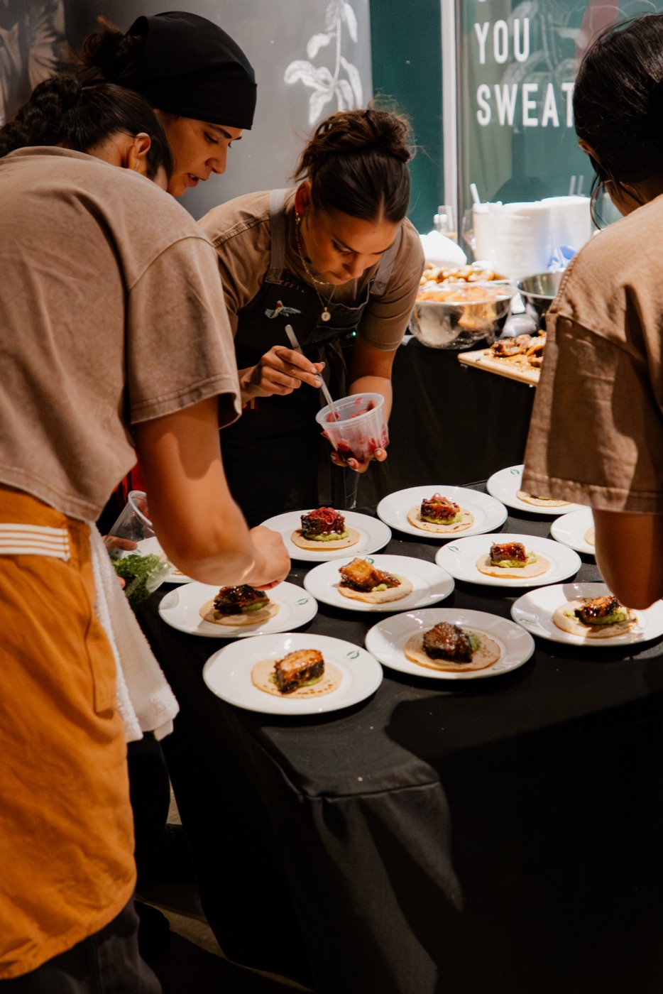 The kitchen team plating together
