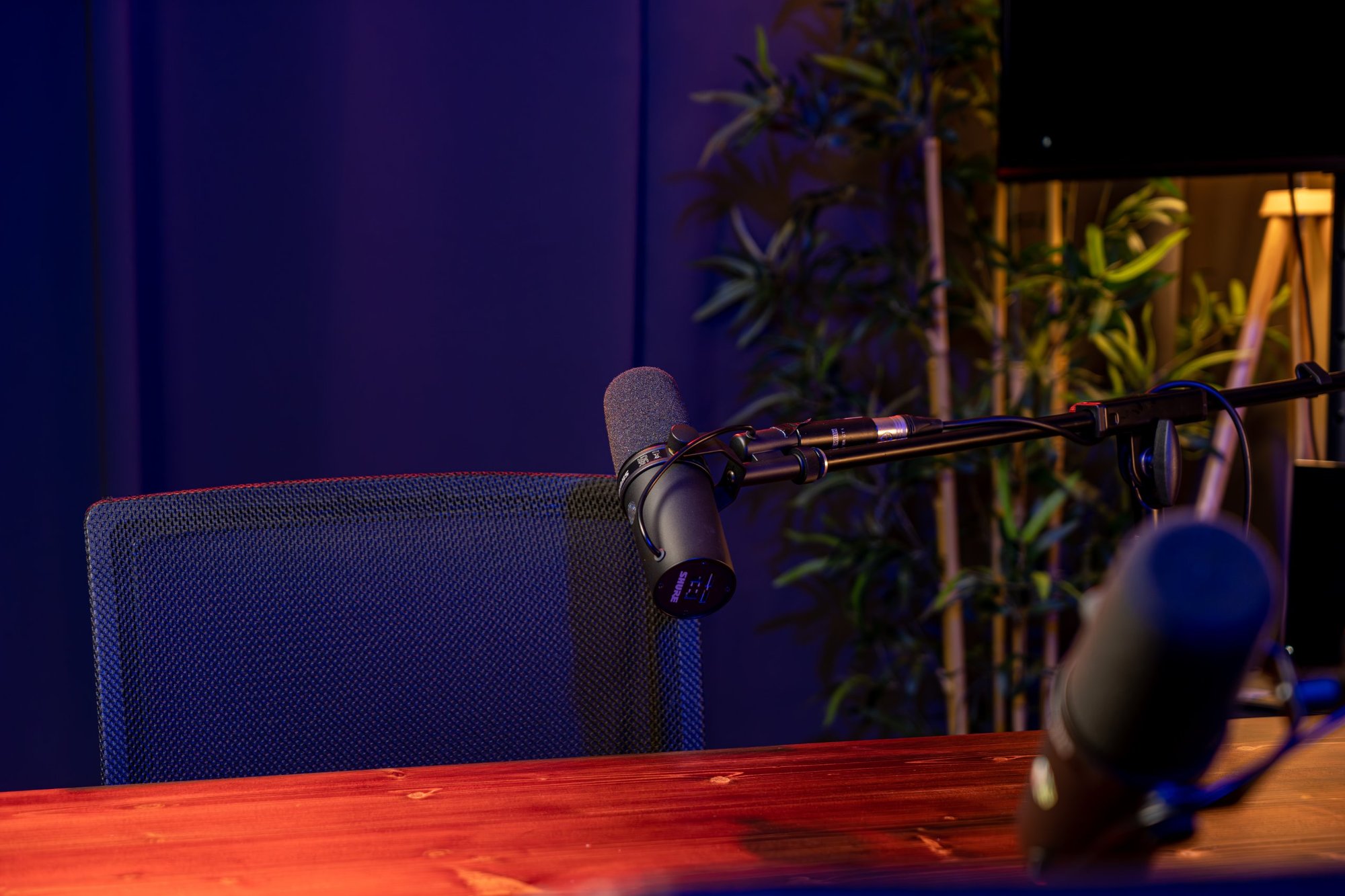 Microphone and chair at the podcast table in Modal's Bangkok studio