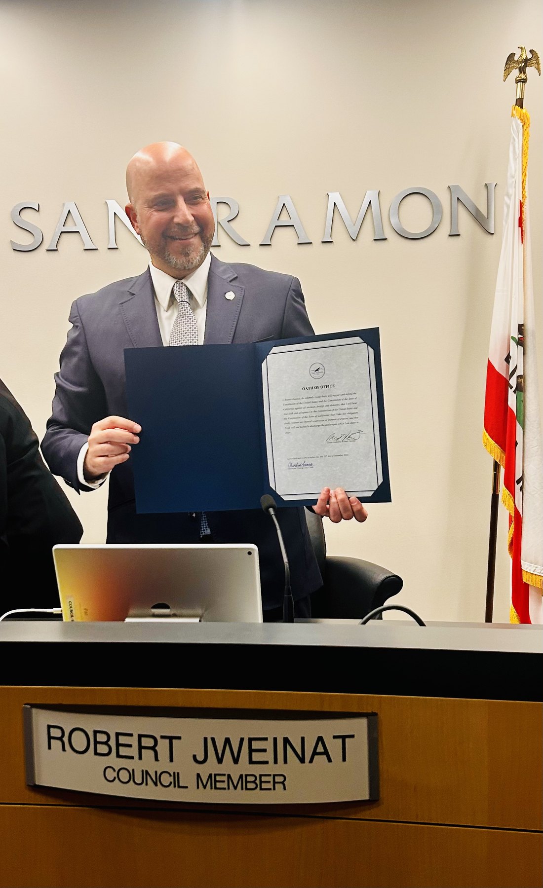 Robert N. Jweinat holding his oath of office as San Ramon Council Member
