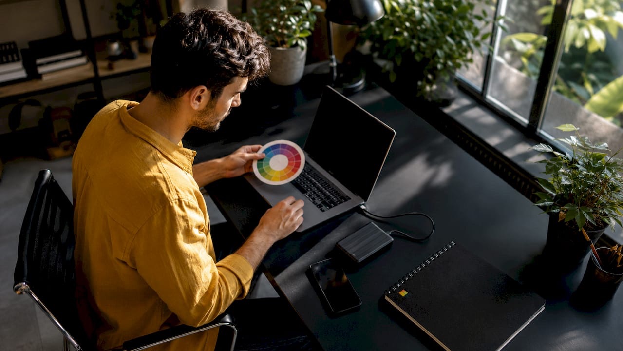Hands adjusting image specs for Meta ads