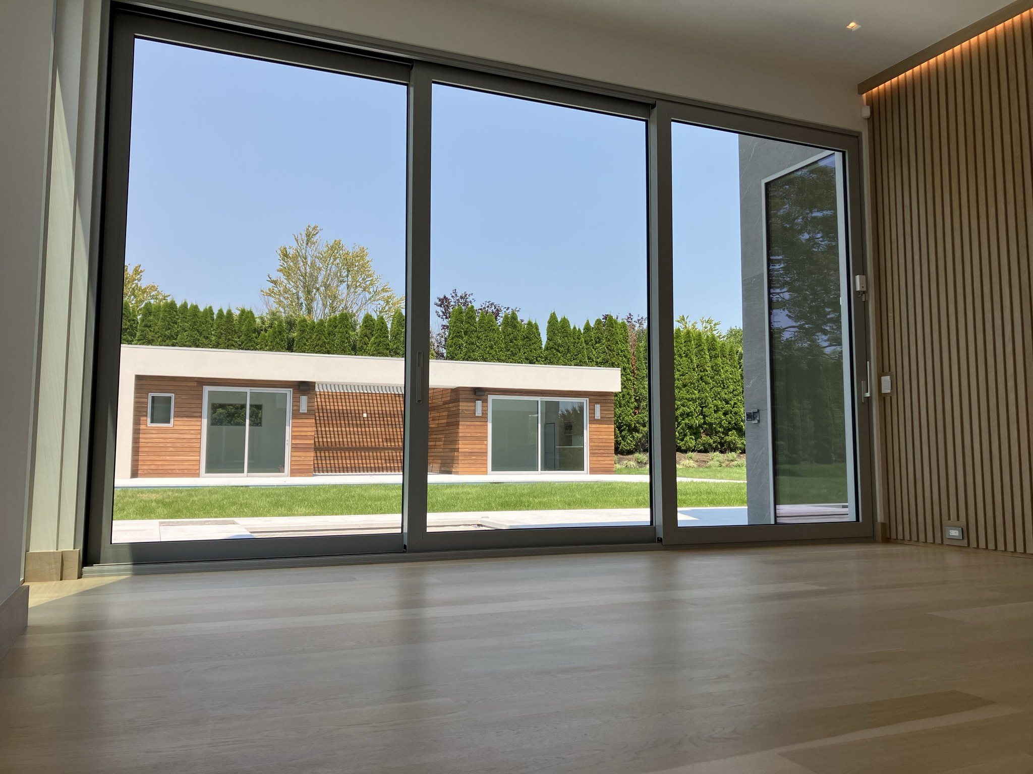 Floor-to-ceiling slim sliding glass wall opening to the garden, Bridgehampton, NY