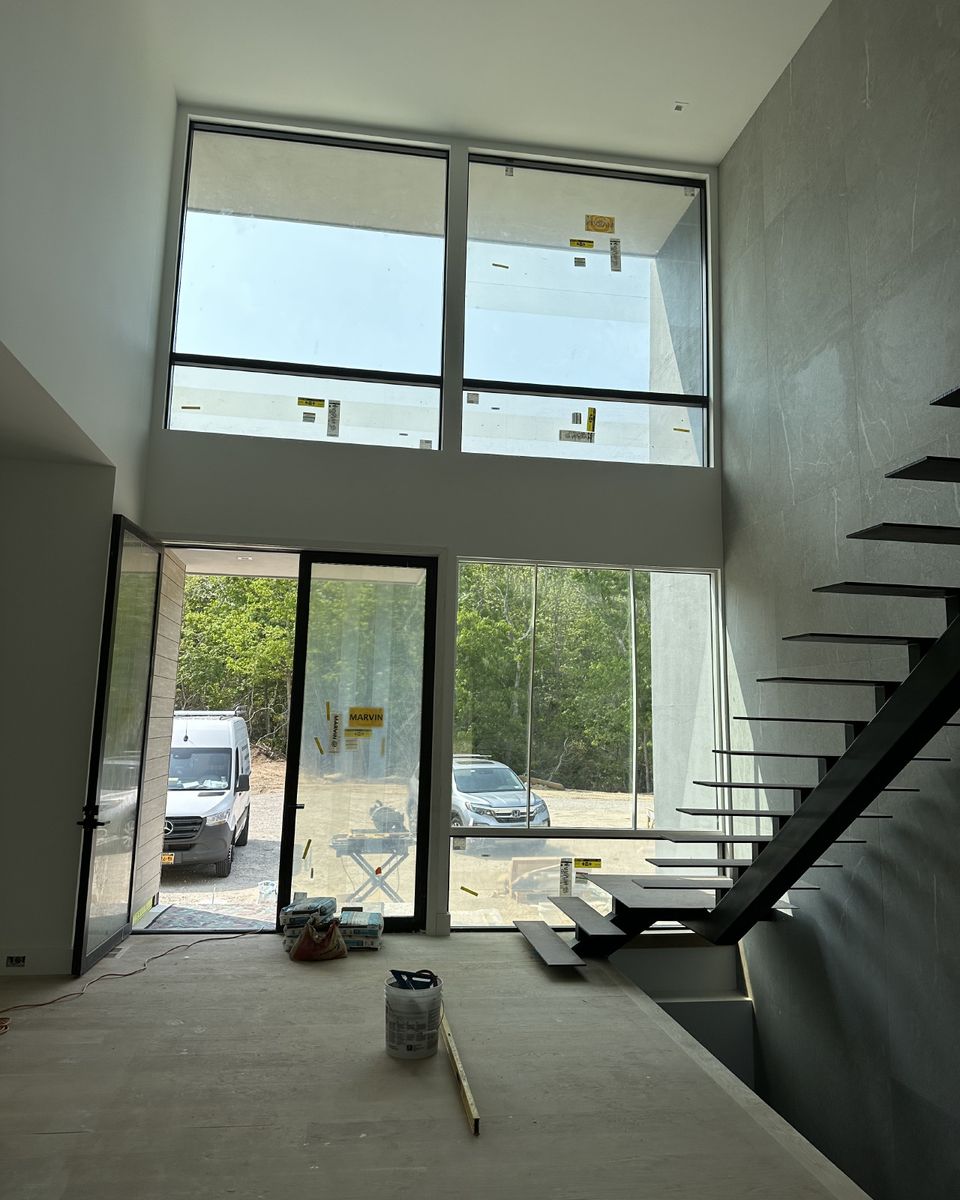 Single-brand window package in a two-story stair hall, during construction