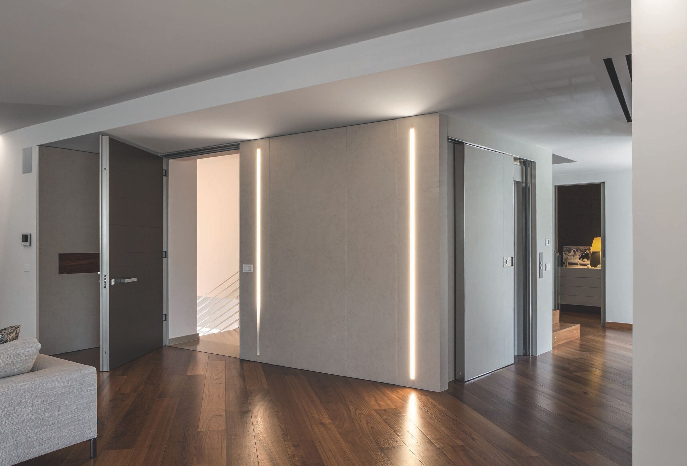 Ceiling-height sliding entrance door in a modern interior