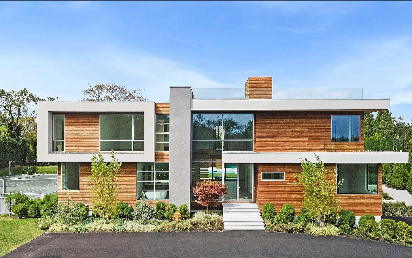 Front elevation of a finished cedar and stucco modern home with Westline slim-frame glazing