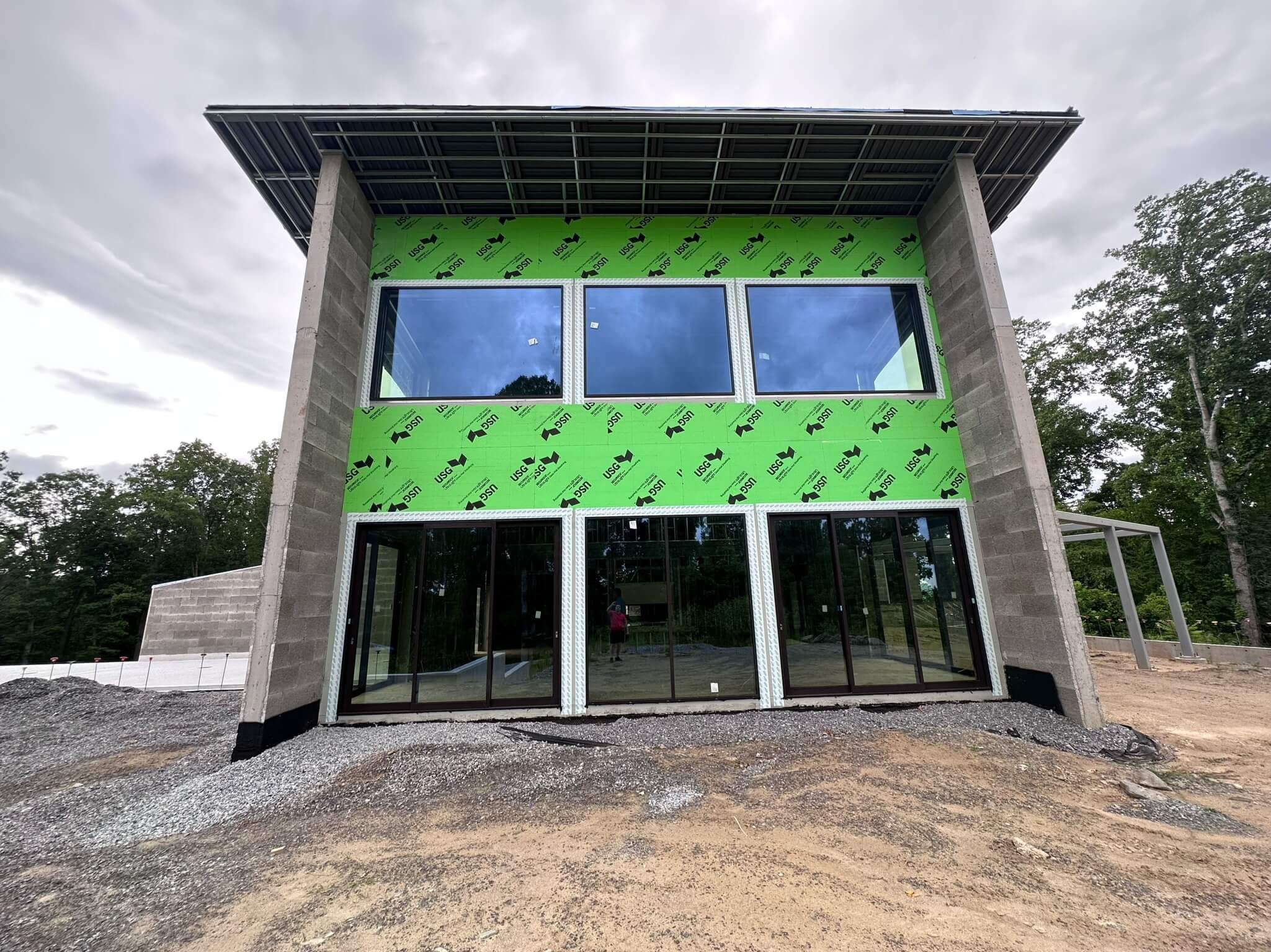 Two-story glazed facade with rows of Westline windows on a home under construction in Fletcher, NC