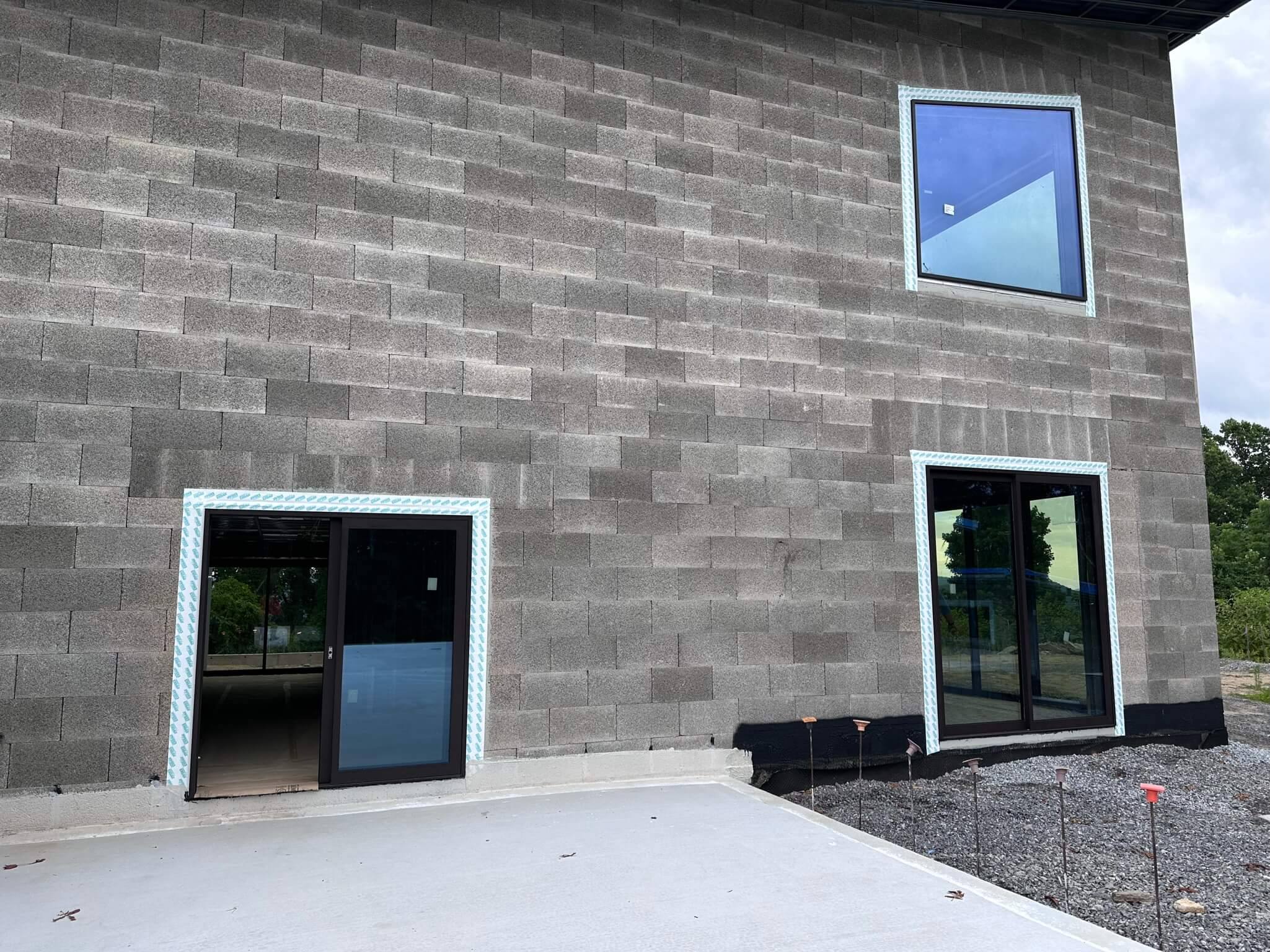 Block wall with a Westline glass door and windows on a home under construction in Fletcher, NC