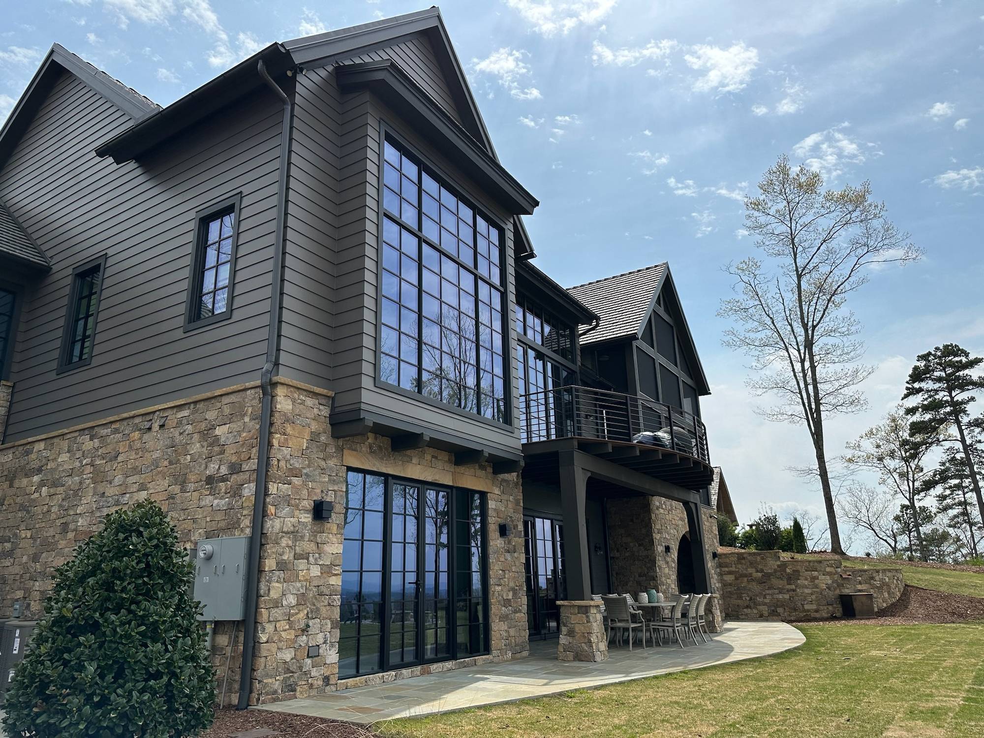 Corner of a lake home at Lake Keowee, SC with stacked black-framed Westline windows and glass doors