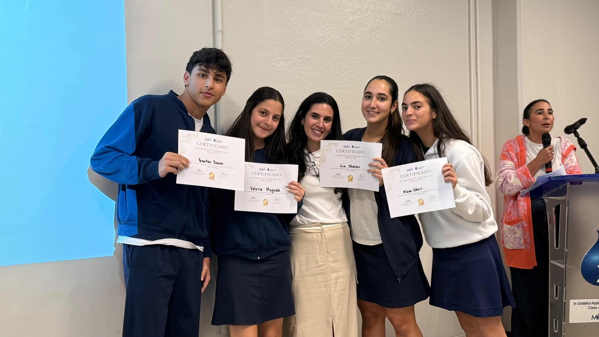 El equipo de Entre Sus Brazos sosteniendo sus certificados al proyecto con mayor impacto.