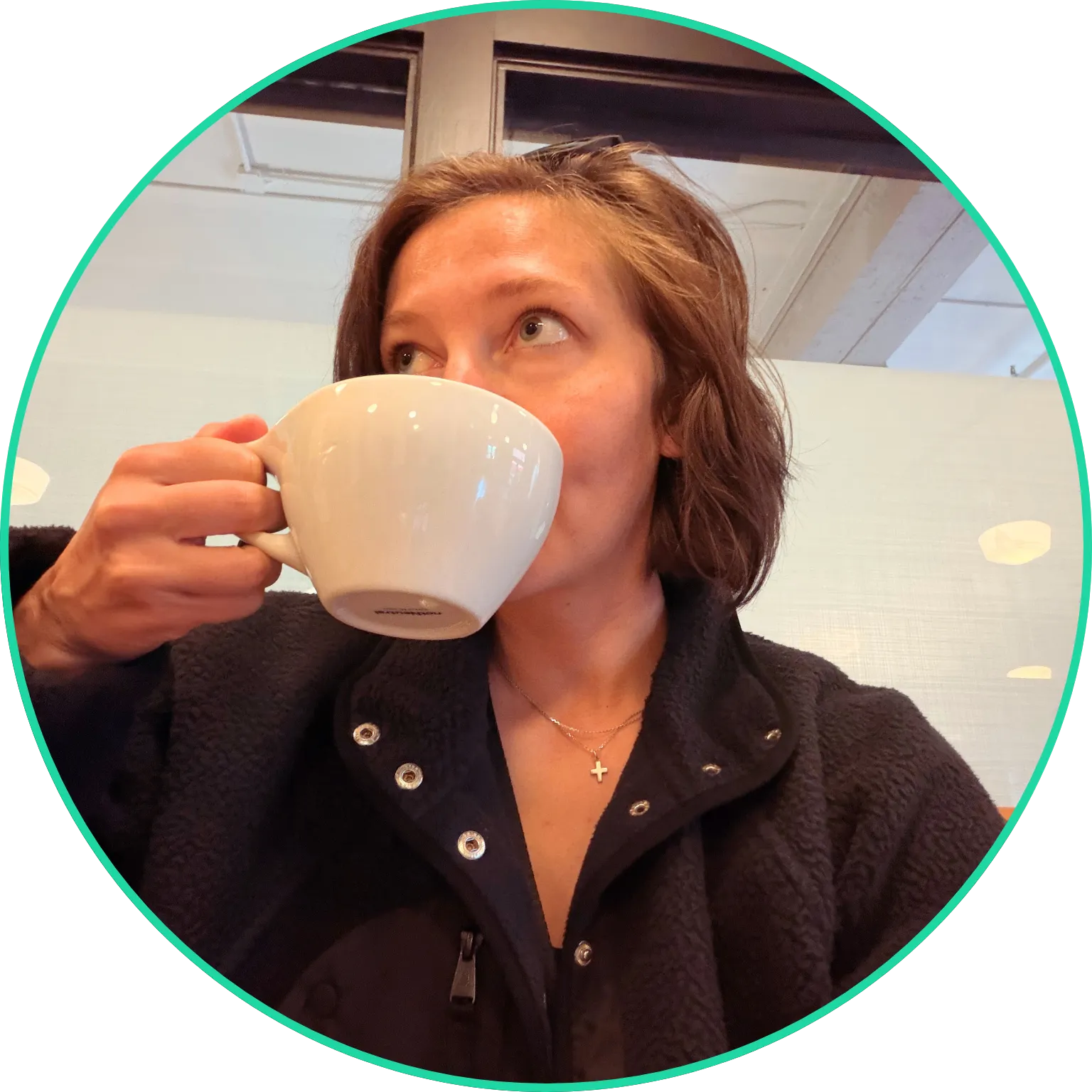 Jessie drinking coffee at a coffee shop