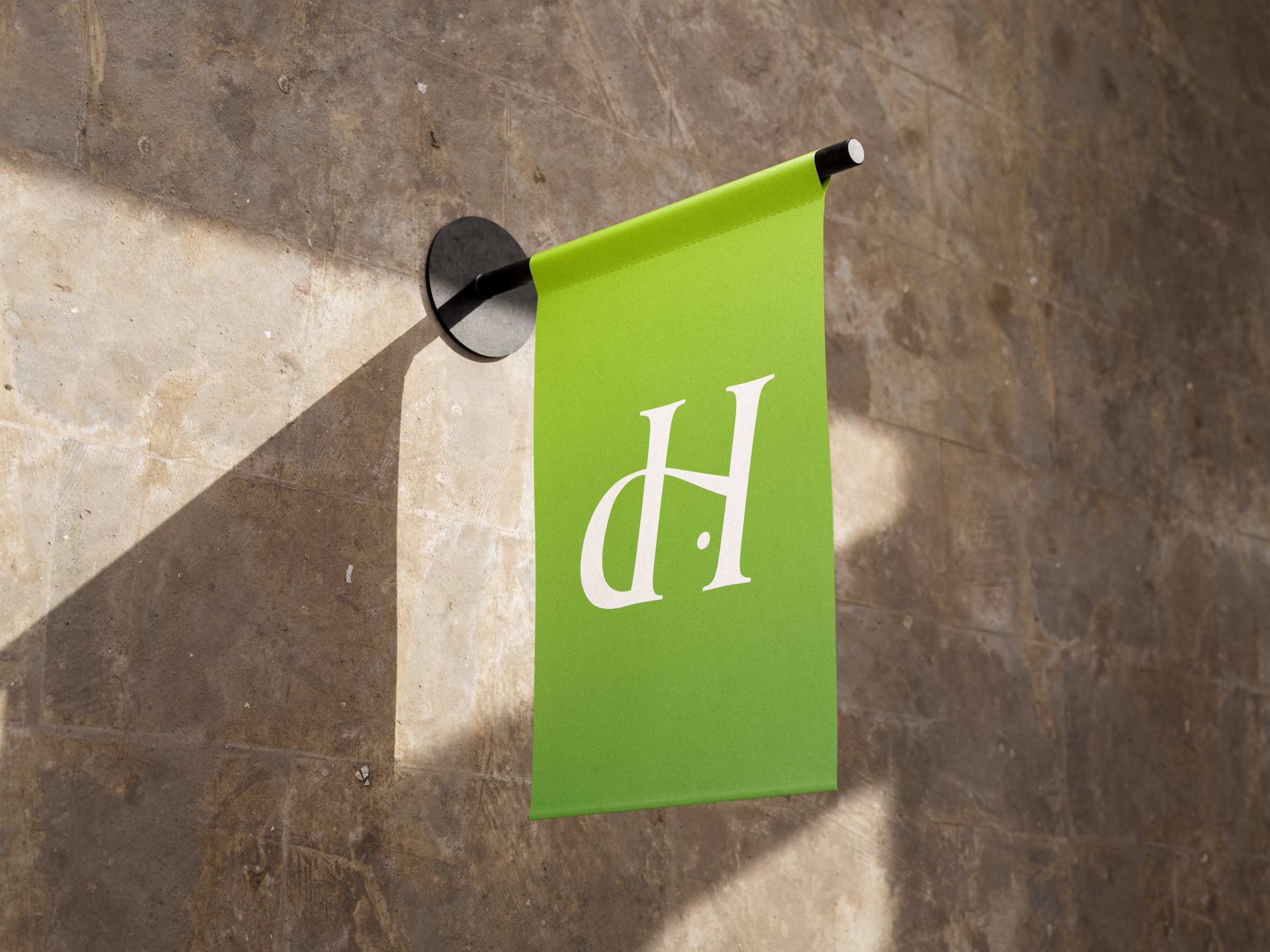 Green wall-mounted flag with the Resolution House monogram