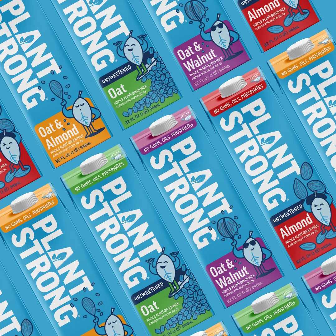Rows of Plantstrong oat and almond milk cartons in assorted flavors